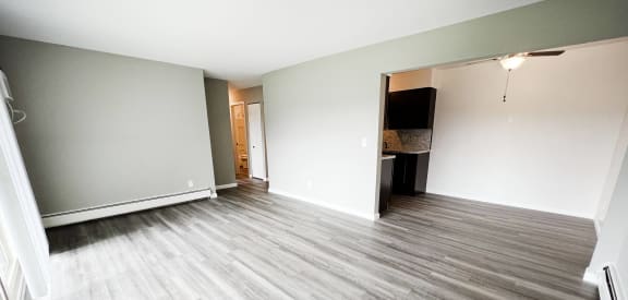 an empty living room with vinyl flooring in a new home at Crown Pointe Apartments, Kentucky, 41014