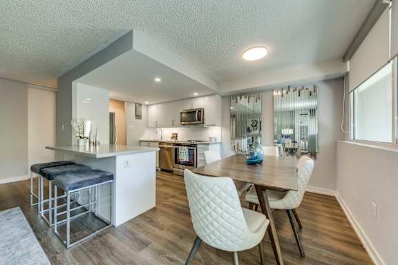 A modern kitchen with a dining table and chairs.