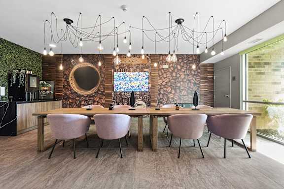 A conference room with a long table and chairs.