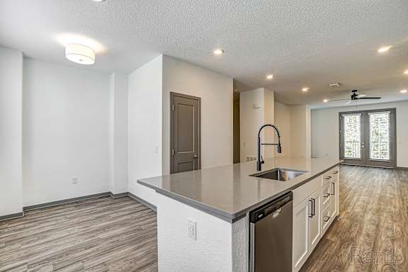 A kitchen with a dishwasher and a refrigerator.