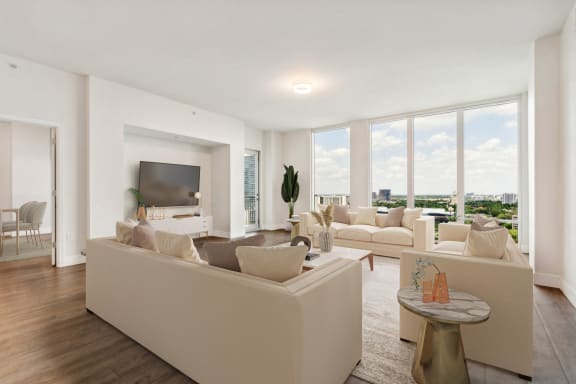 a living room with white couches and a large window at Paramount on Lake Eola, Orlando, 32801
