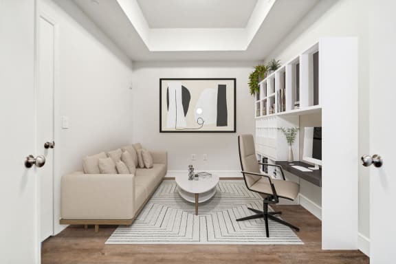 a living room with a couch and a table and a desk at Paramount on Lake Eola, Orlando, FL