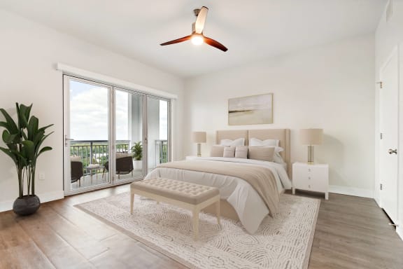 a white bedroom with a bed and sliding glass doors at Paramount on Lake Eola, Orlando, 32801