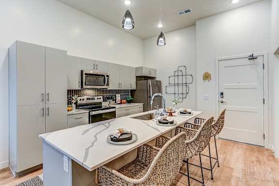 A kitchen with a table and chairs set for two.