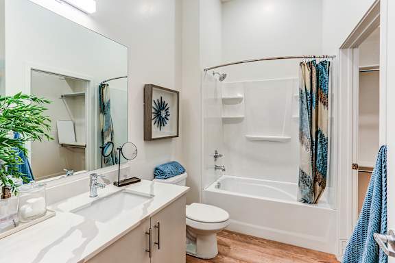 A bathroom with a white sink, toilet, and bathtub.