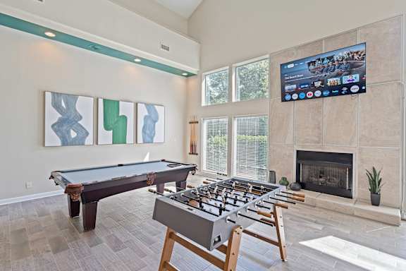 a games room with a foosball table and a fireplace