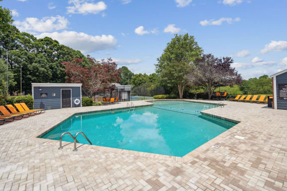 a swimming pool in the backyard of a house with a pool