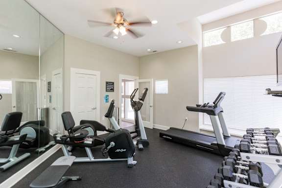 the gym with treadmills and ellipticals at the enclave at woodbridge apartments at Beacon Ridge Apartments, Greenville, SC, 29615