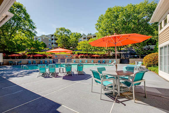 a patio with a pool and tables with umbrellas at Beacon Ridge Apartments, Greenville, SC, 29615