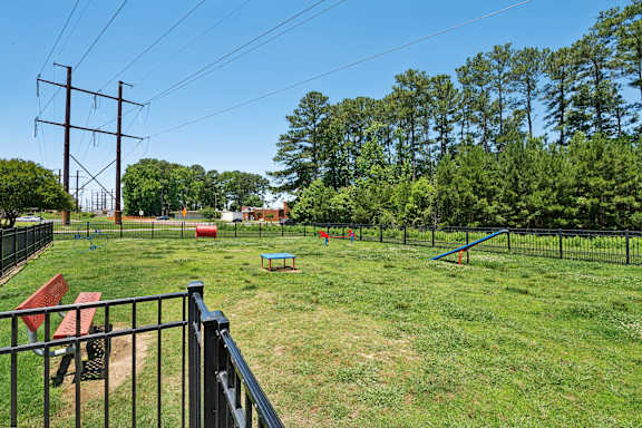 the yard is fenced in with a playground and a picnic table at The Courtyards of Chanticleer, Virginia Beach, VA