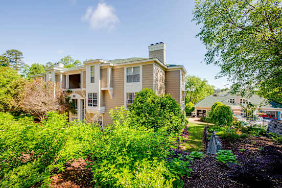 the view of the house from the yard with trees and bushes at Beacon Ridge Apartments, Greenville, SC, 29615