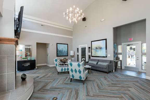 a living room with couches and chairs and a chandelier at Beacon Ridge Apartments, Greenville, SC, 29615