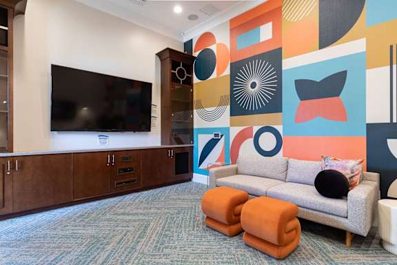 A living room with a grey couch and a television.