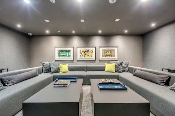 A modern living room with grey couches and a coffee table.