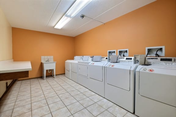 a row of washers and dryers in a laundry room at France, North Dakota