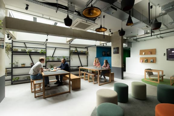 a group of people sitting at tables in a room