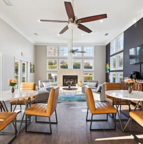 a living room with tables and chairs and a fireplace