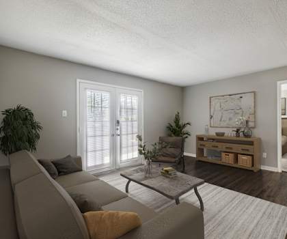 A living room with a grey couch and a coffee table.