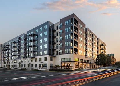 A modern apartment building with a street in front of it.