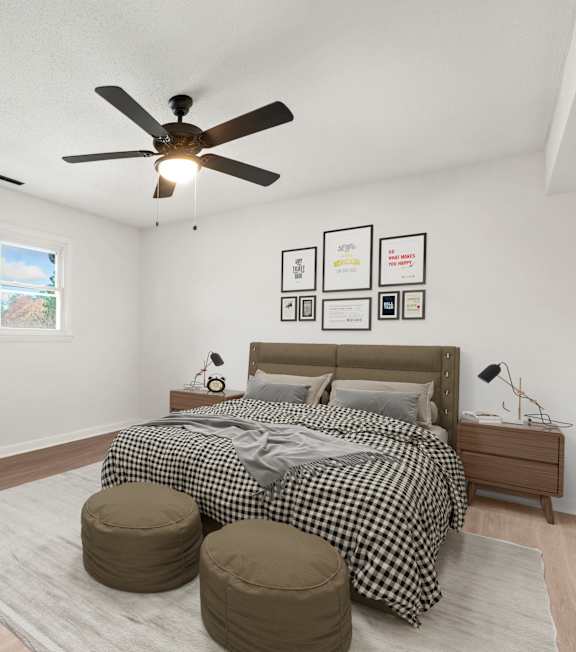 a bedroom with a bed and a ceiling fan