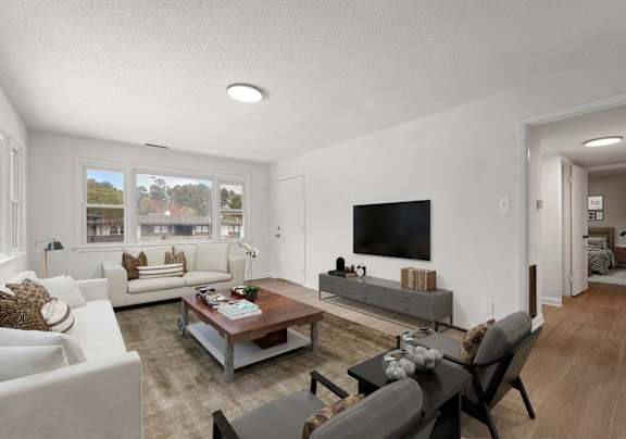 the living room of an apartment with couches and a table