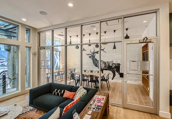 a wall of glass separates the kitchen from the living room