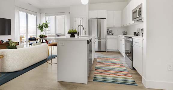 A modern kitchen with white cabinets and a central island.