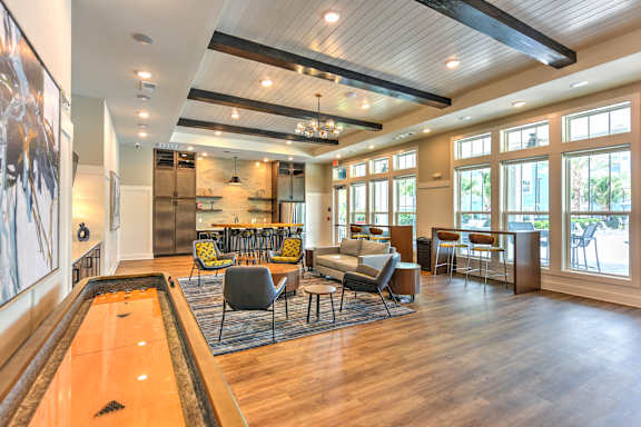 A billiard table is in the middle of a well-furnished room.