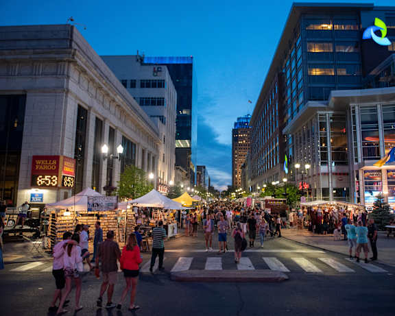 people walking through a street festival in a city at night at Center Square Lofts West, Allentown