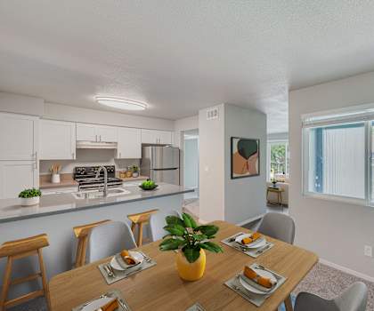 an open kitchen and dining room with a table and chairs at 2300 West Apartments, Nevada, 89502