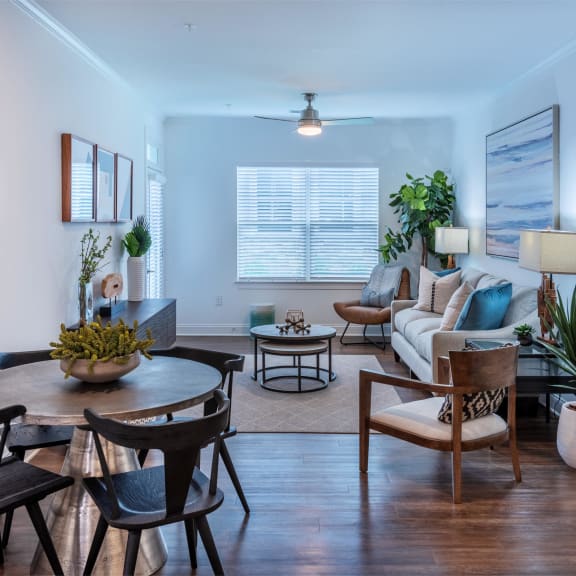 a living room with blue couches and chairs and a fireplace