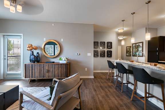 an open living room and dining room with a bar and a kitchen at Watermark at Harvest Junction, Colorado