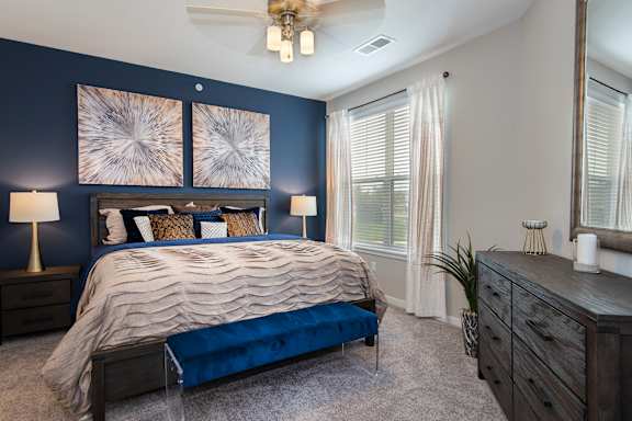a bedroom with a large bed and a ceiling fan at Watermark on Twenty Mile, Parker, 80134