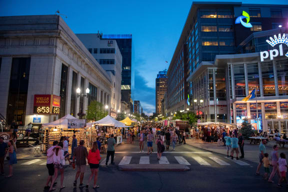people walking through a street festival in a city at night