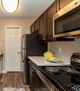 a kitchen with stainless steel appliances and marble counter tops