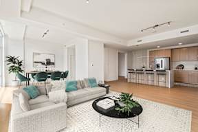 A modern living room with a white sofa and a coffee table.