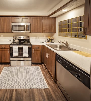 Fully Equipped Kitchen Includes Frost-Free Refrigerator, Electric Range, & Dishwasher at Castle Point Apartments, South Bend, Indiana