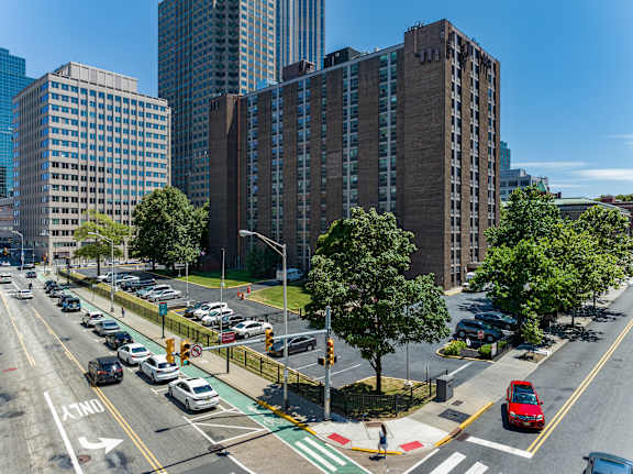 an aerial view of a busy city street with cars and tall buildings