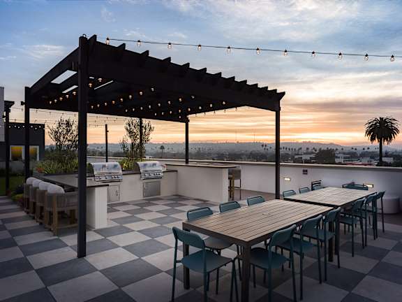 A wooden deck with two chairs and a table at Coro in Los Angeles