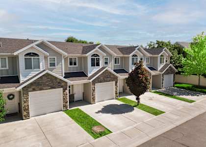 an aerial view of a house with garages and a driveway