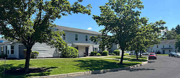 A tree in front of a house.