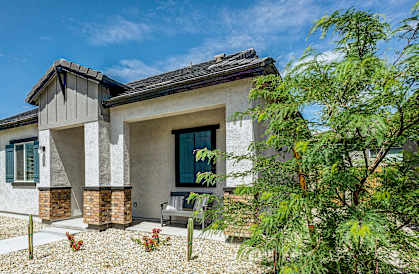 A modern house with a gravel front yard.
