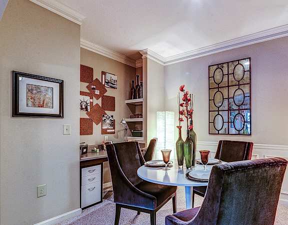 a dining room with a table and chairs