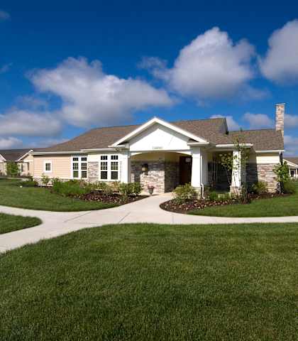 A house with a white fence and a green lawn.