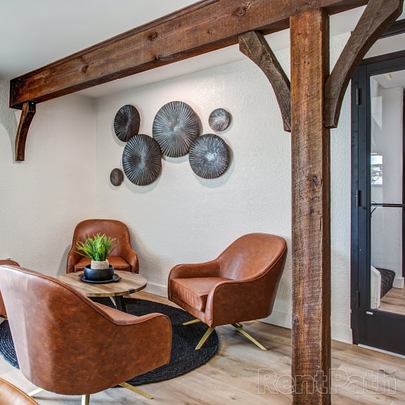 a living room with leather chairs and plates on the wall