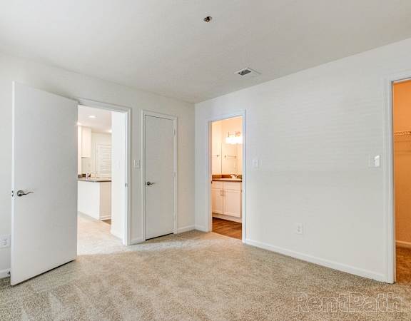 a bedroom with two closets and a door to a bathroom
