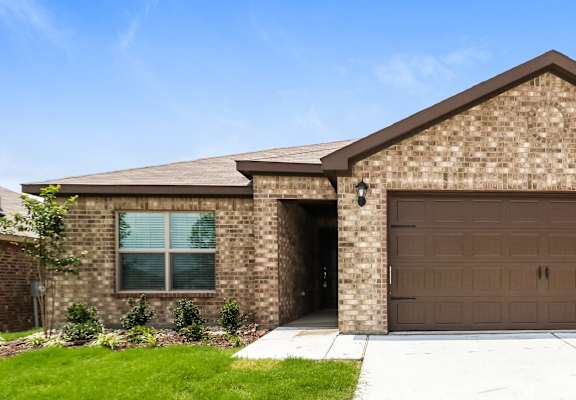 a brown brick house with a brown garage door