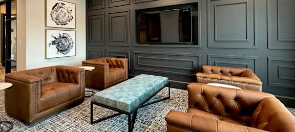 a living room with leather couches and a tv