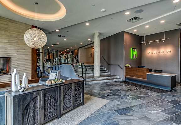 a lobby with a reception desk and a fireplace