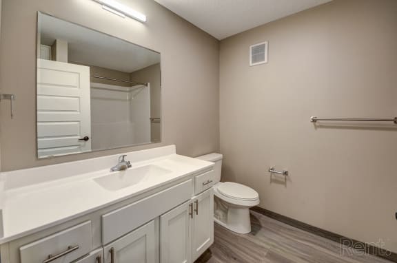a bathroom with a sink toilet and a mirror